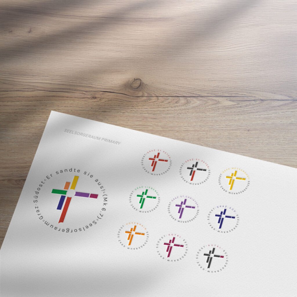 Übersicht mehrerer bunter Kreuz-Logovarianten für den Seelsorgeraum Graz-Südost, dargestellt auf weißem Hintergrund.